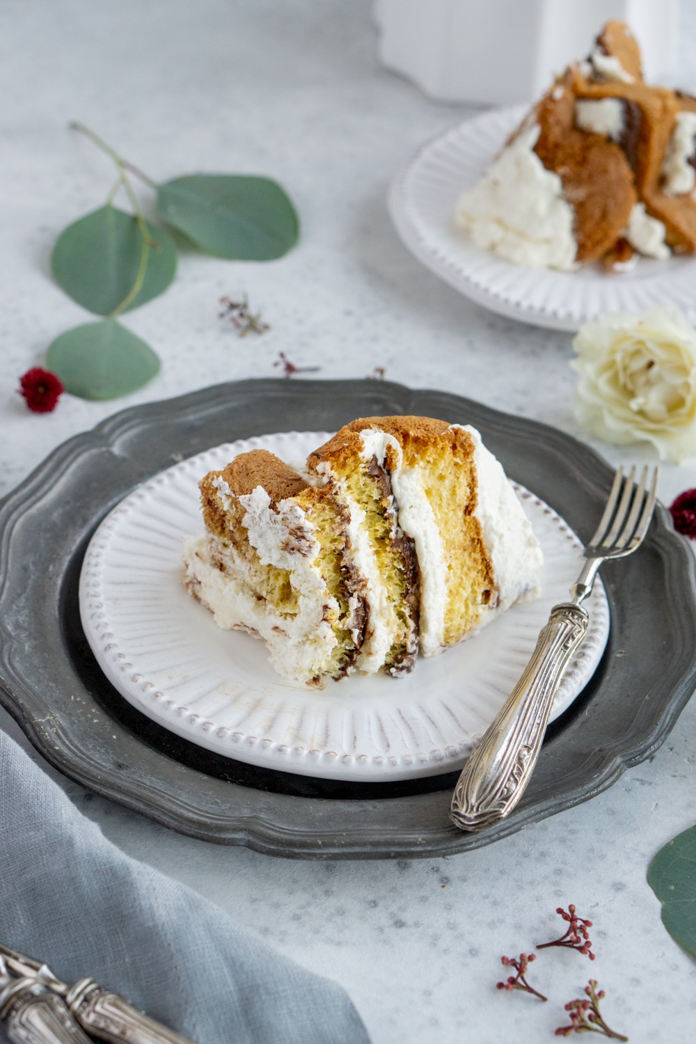 Slice of pandoro tree on a white plate
