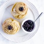 overhead shot of zeppole di san Giuseppe on a white plate with amarena cherries