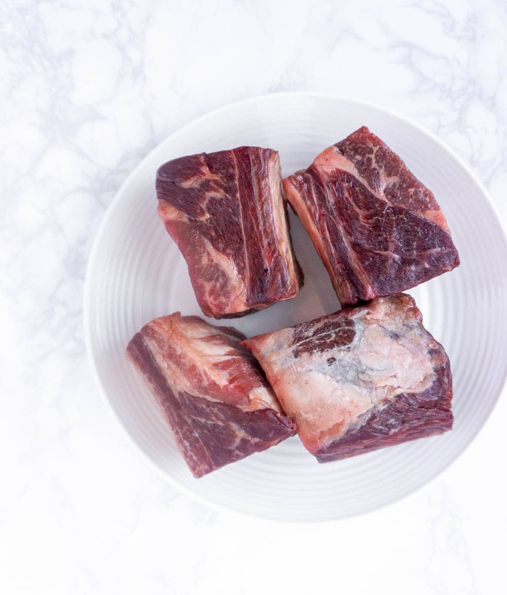 English style short ribs beef short ribs on a white plate