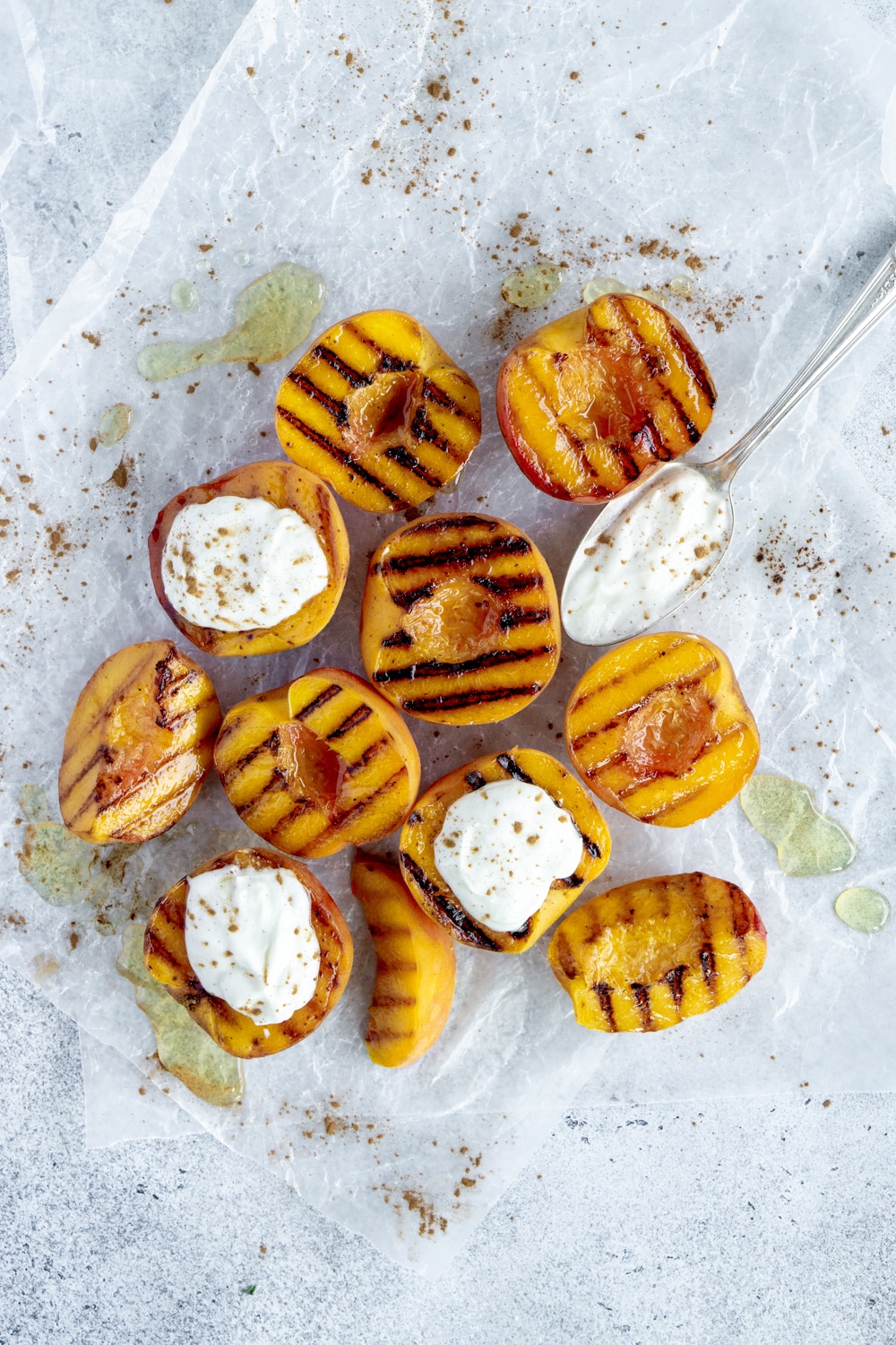 Dessert goals! Grilled peaches with whipped ricotta flavored with honey and vanilla. #grilledpeaches #summerdessert #pinacooks Cluster of grilled peaches with topped with ricotta and a spoon