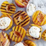 Overhead shot of grilled peaches topped with ricotta