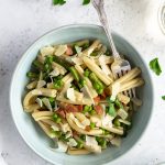 Asparagus pasta overhead shot with 2 glasses of wine