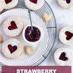Overhead shot of strawberry linzer cookies on a plate and cooling rack