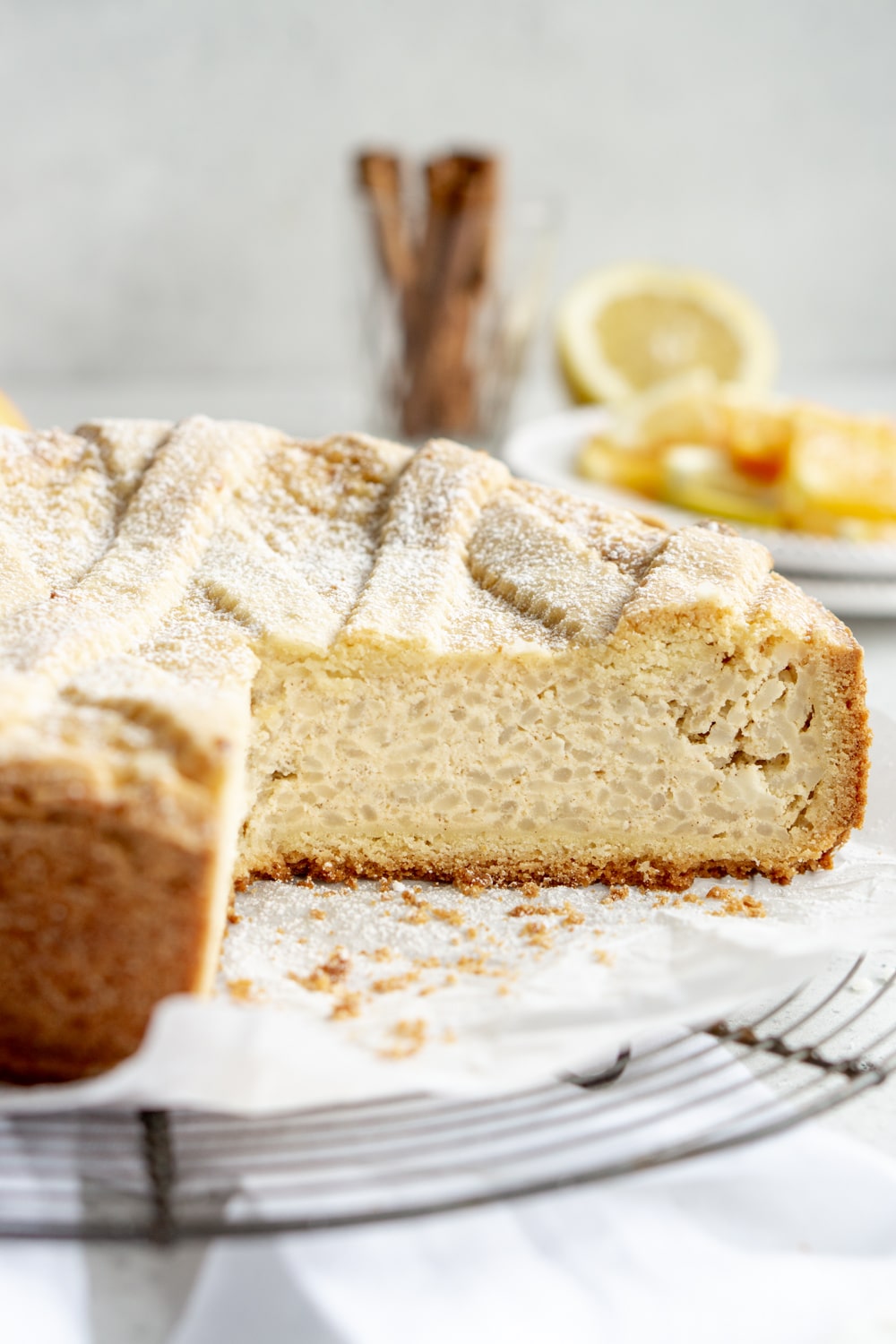 A rice pie on a cooling rack with a large slice cut out
