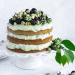 pistachio cake on a white cake stand