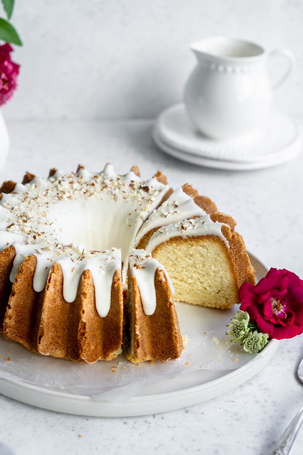 Easy homemade almond cake with a beautiful amaretto glaze. #almondcake #italiandesserts #pinacooks almond bundt cake on a plate with a slice taken out