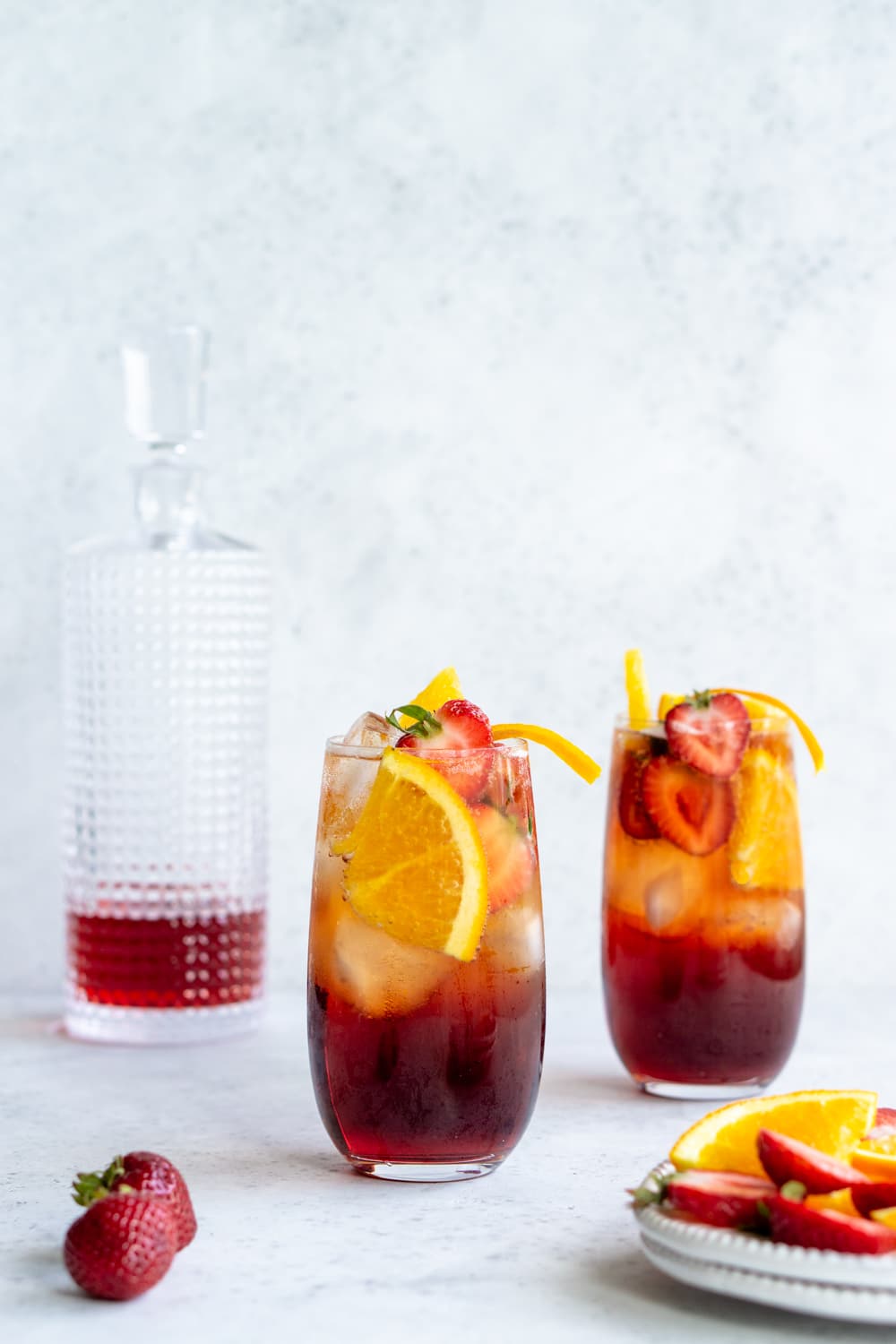 Love this americano cocktail! The perfect mix of bitter and refreshing flavors. #italiancocktails #italiandrinks #americanococktail #pinacooks 2 glasses with americano cocktails in them with a decanter in the background
