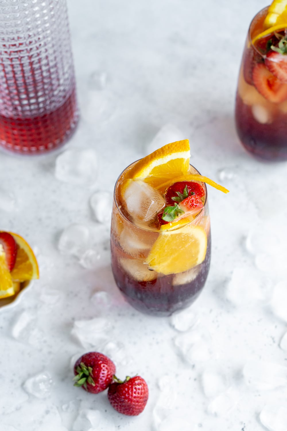 What a gorgeous cocktail! The americano is made with campari, sweet vermouth and club soda. Perfect for a hot summer's day. #italiancocktails #italiandrinks #americanococktail #pinacooks americano cocktail in a glass surrounded by ice cubes
