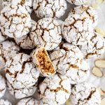 Overhead shot of many amaretti cookies and sliced almonds