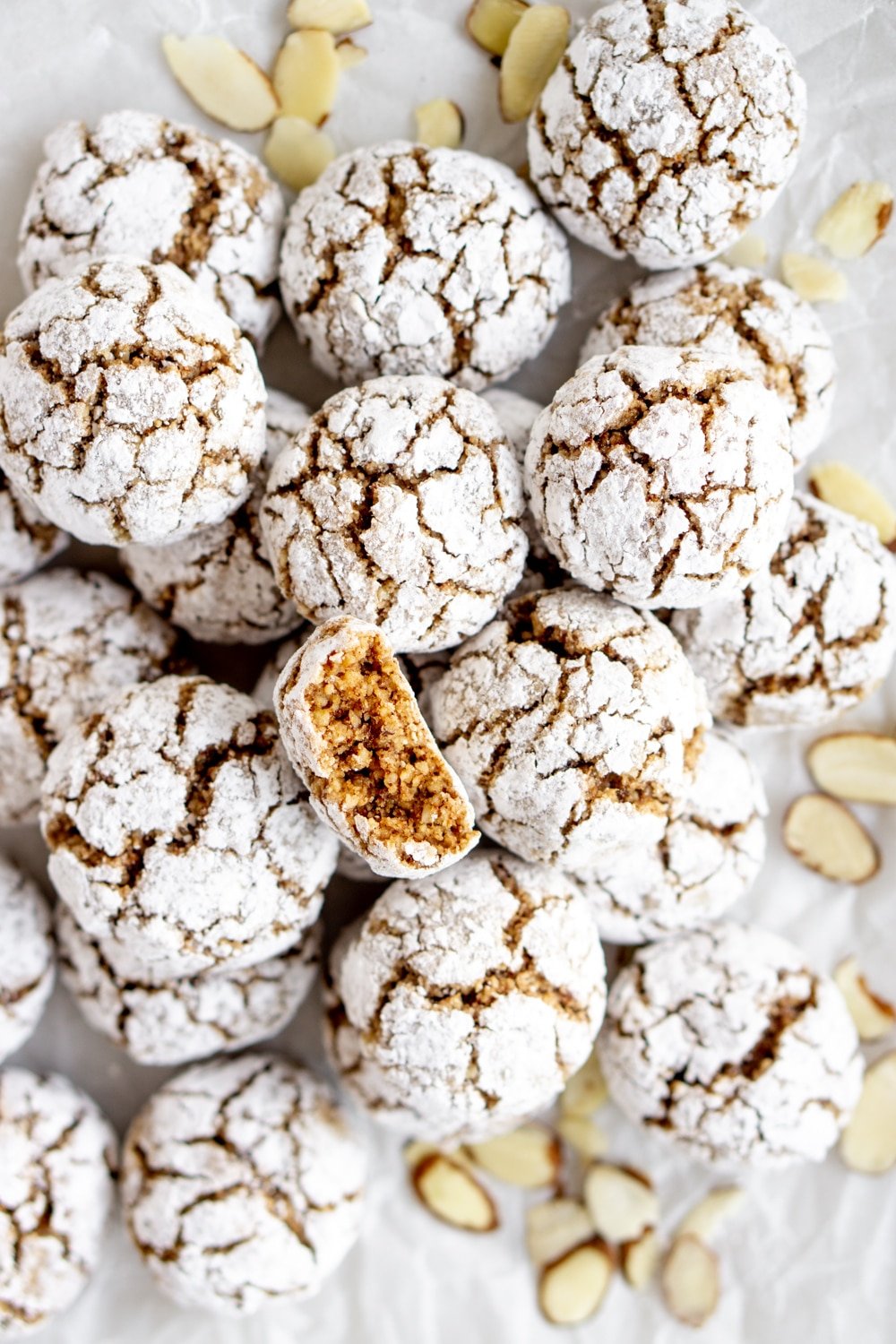 Overhead shot of many amaretti cookies and sliced almonds