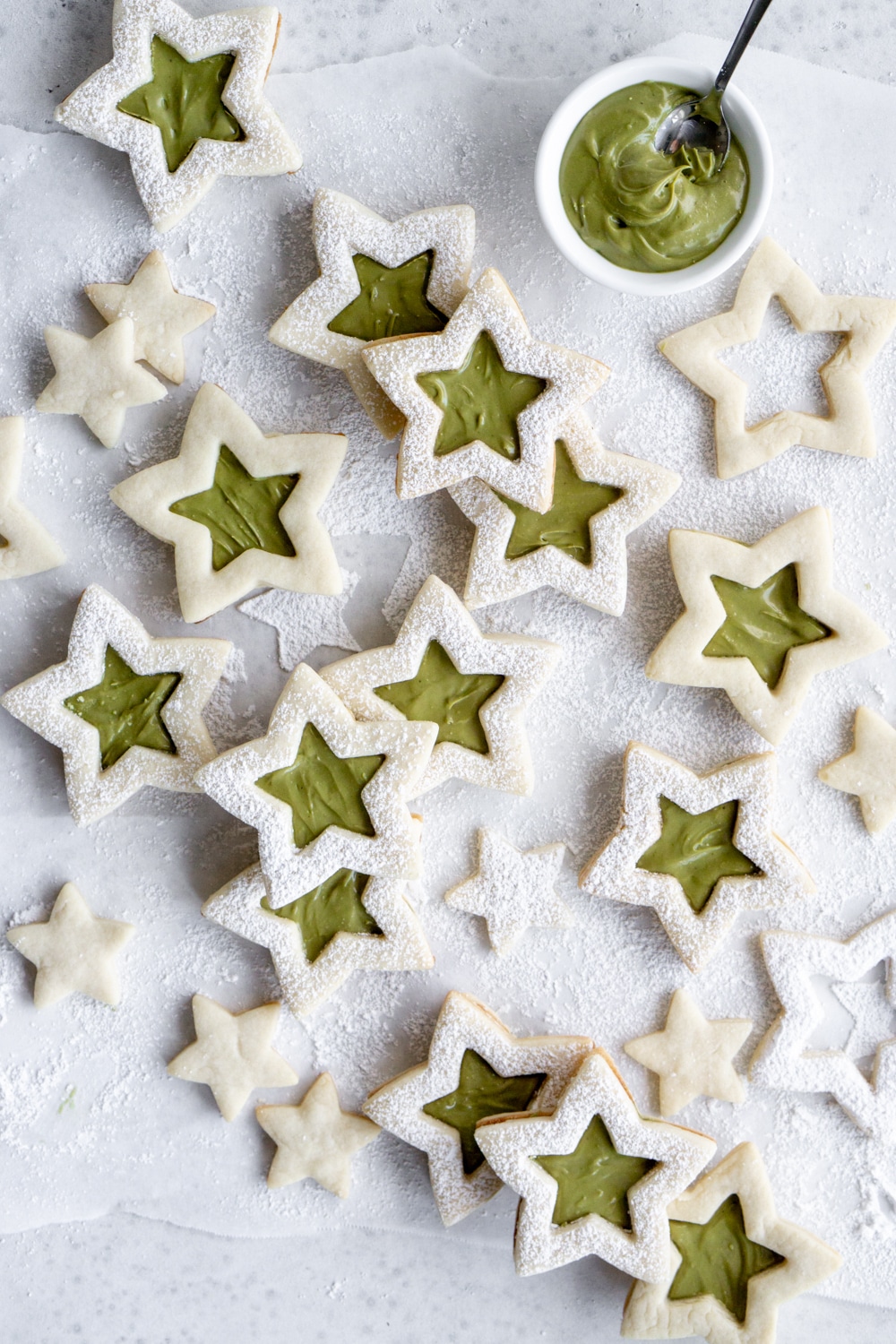Grouped star cookies with a bowl of pistachio cream