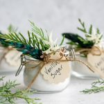 Three jars of vanilla sugar decorated with fresh greenery and tags