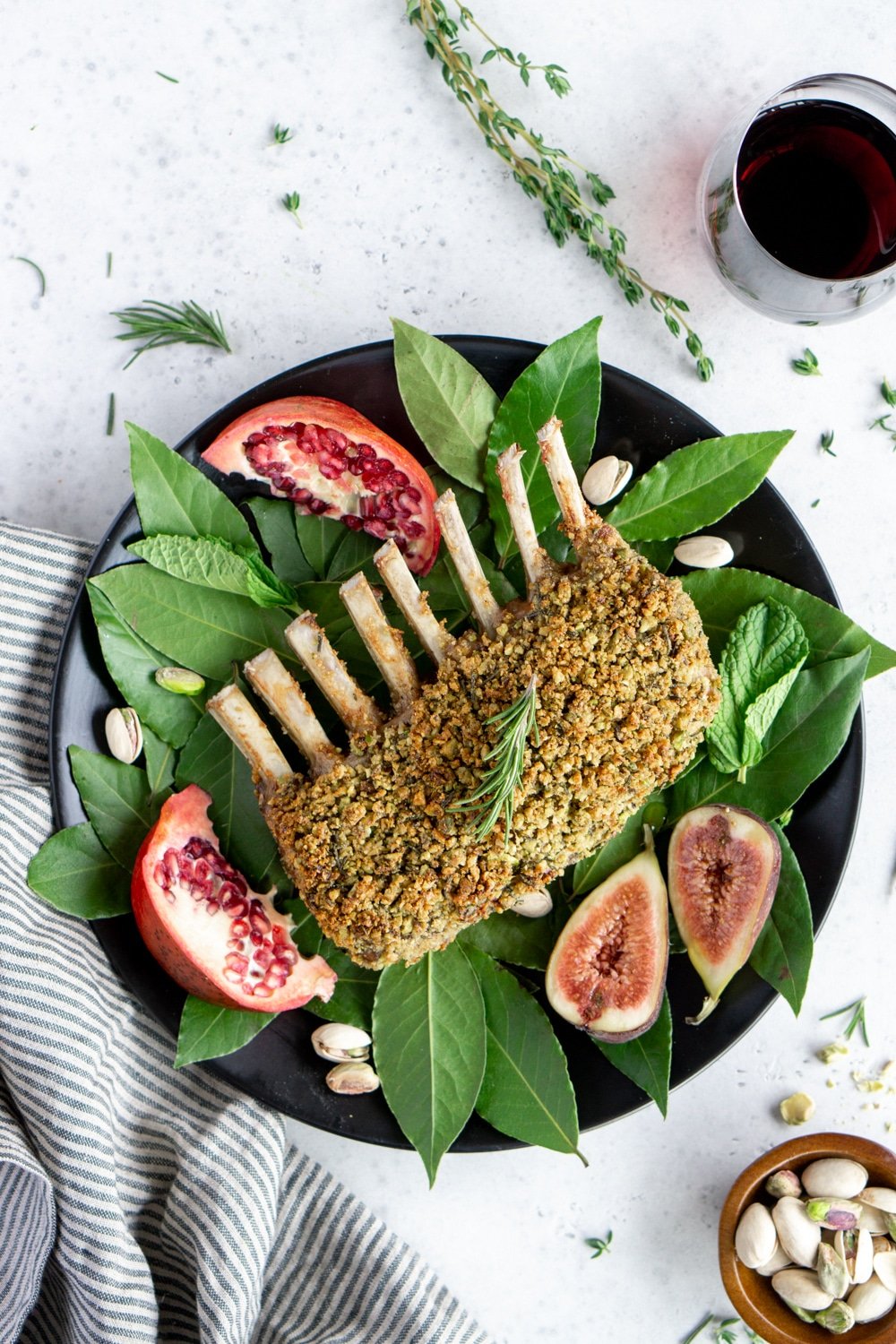 Roasted rack of lamb on a plate and a bed of bay leaves