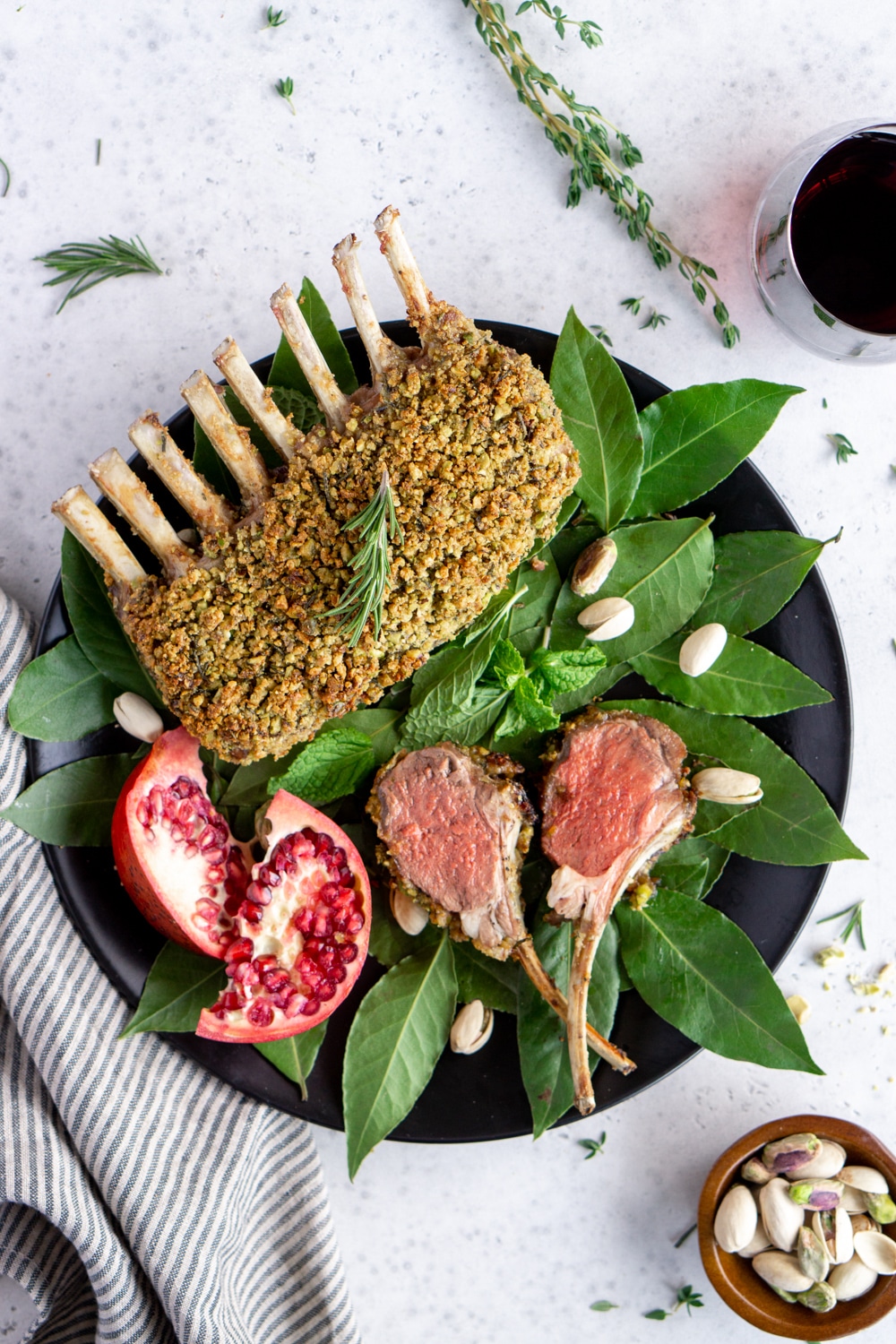 Roasted rack of lamb on a plate with two lamb chops