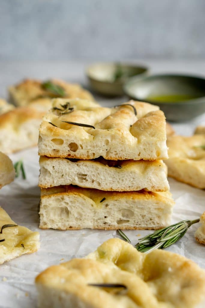 Three square pieces of focaccia pizza stacked on top of each other