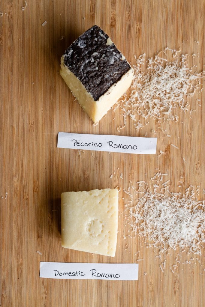 Pieces of pecorino romano and domestic romano on a wood board