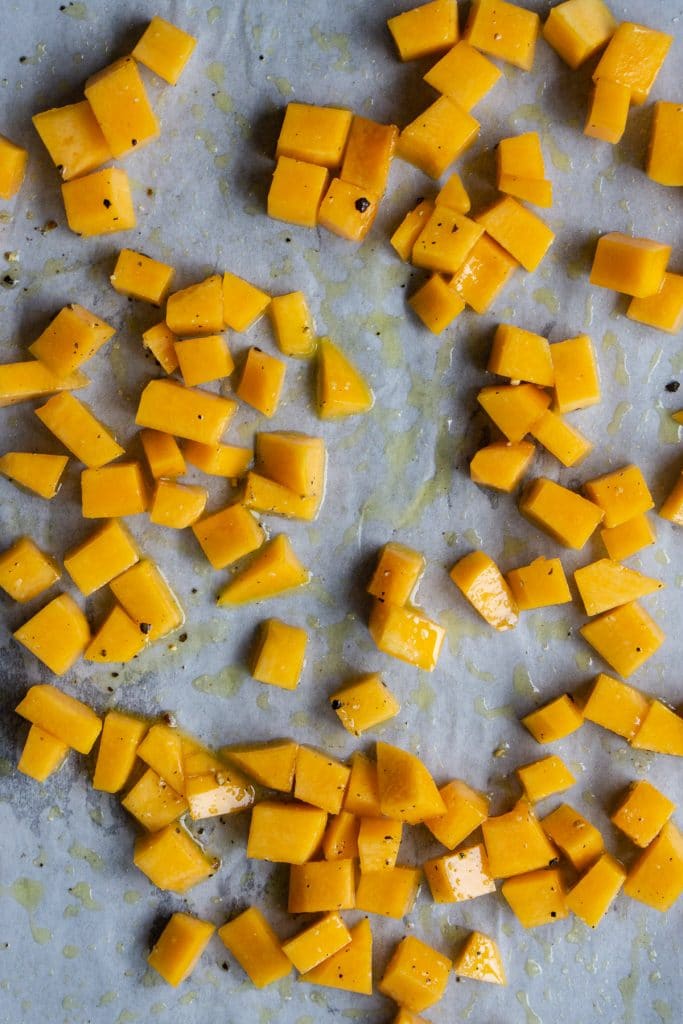 Cubed butternut squash on a baking tray