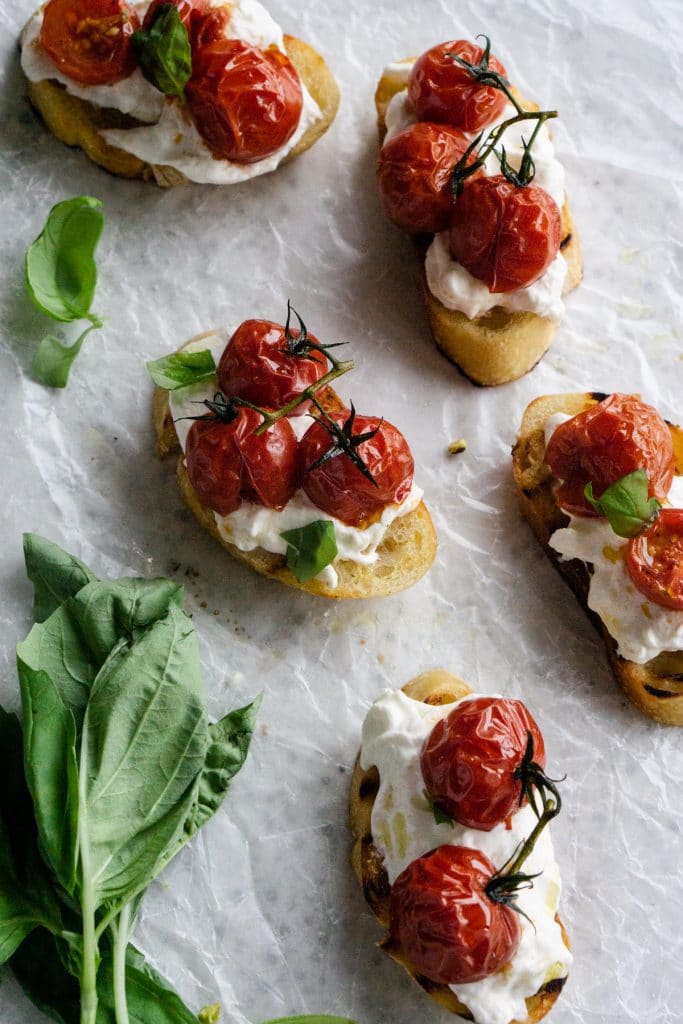 Roasted tomato crostini on parchment paper