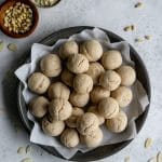 Overhead shot of fave dei morti in a gray dish with almonds scattered around