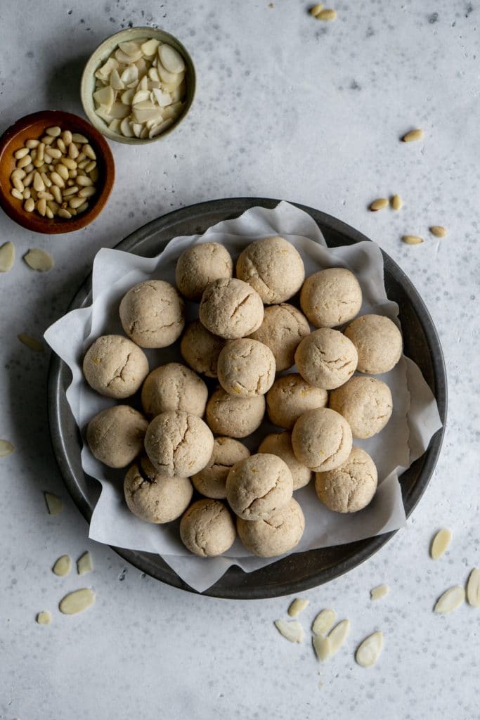 Overhead shot of fave dei morti in a gray dish with almonds scattered around