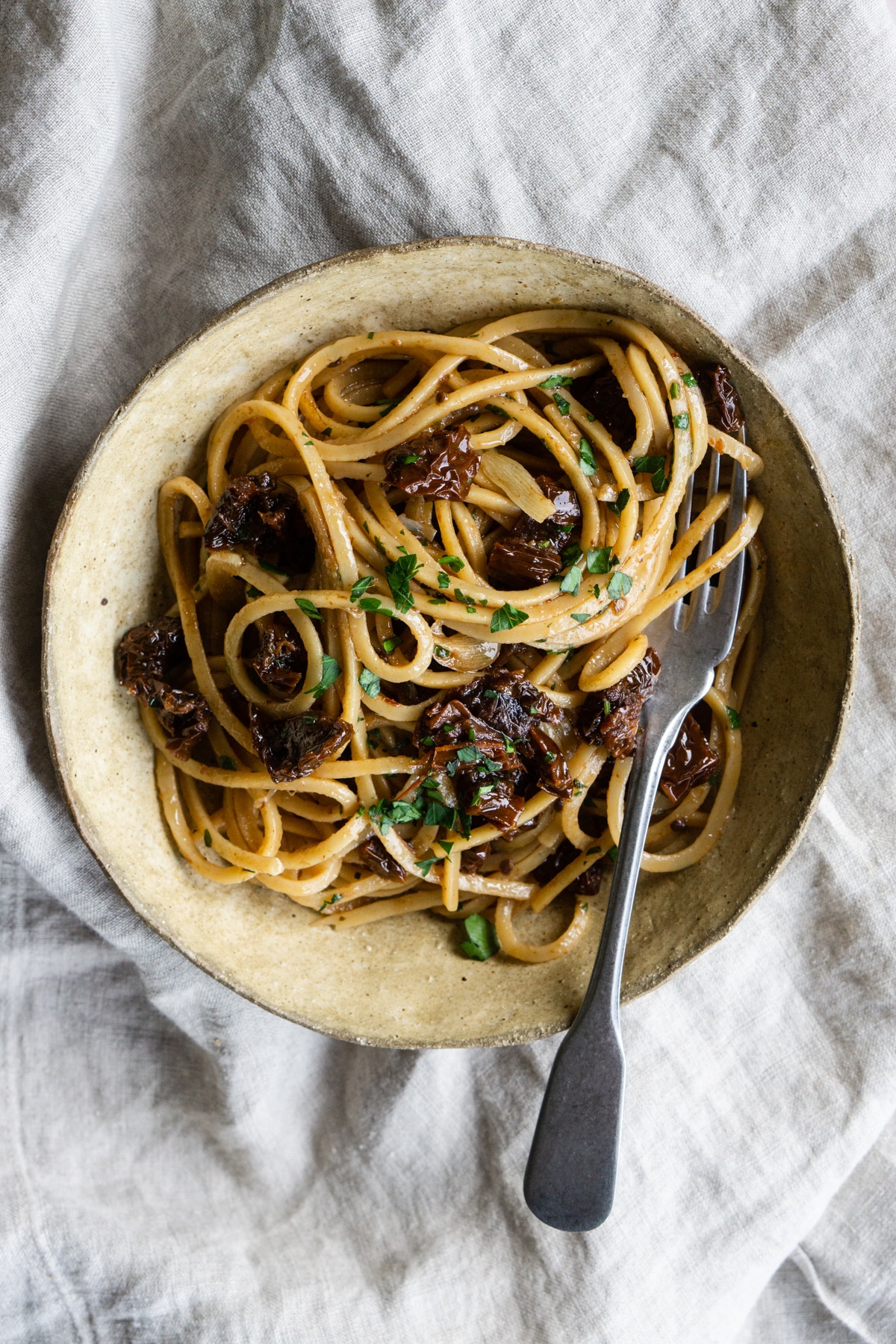 Sun dried tomato pasta in a bowl with a fork