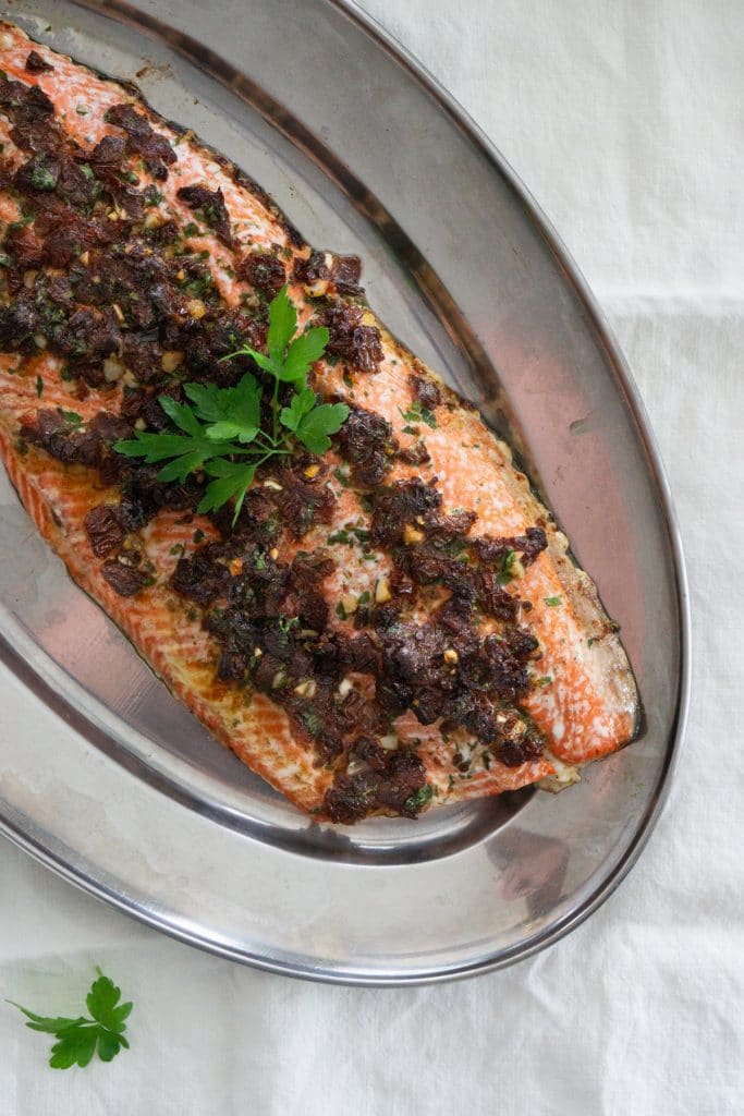 Sun dried tomato salmon on a metal serving tray
