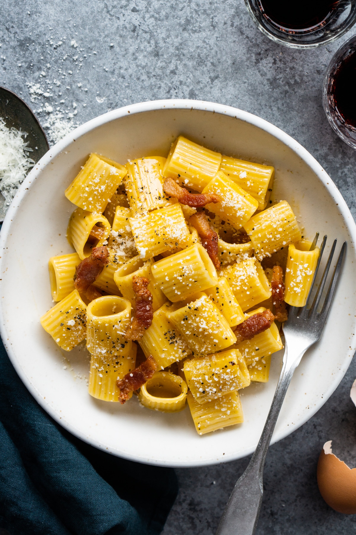 authentic carbonara in a white bowl with a fork