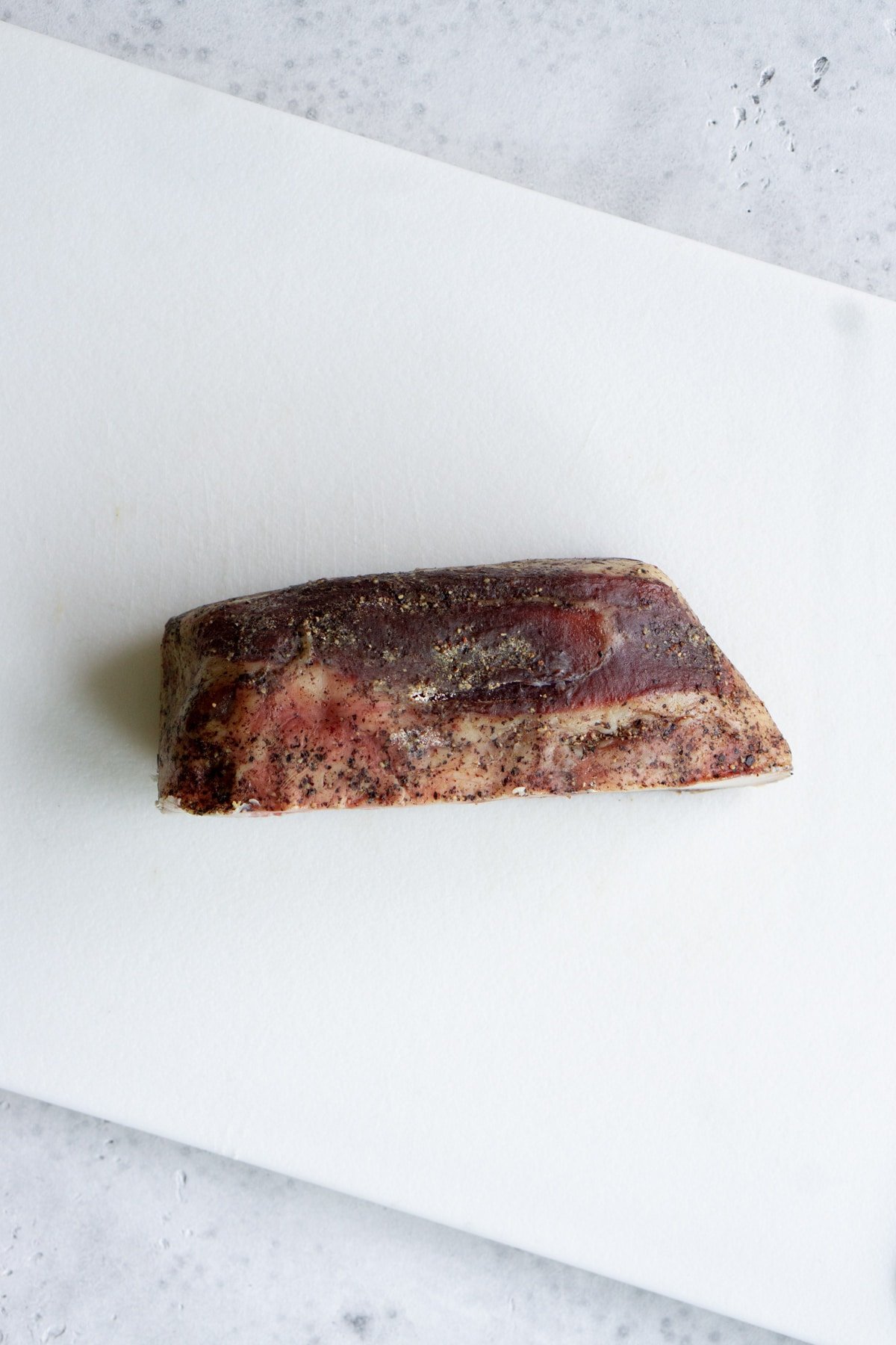 Piece of guanciale on a cutting board