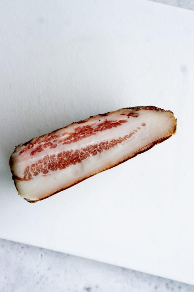 Piece of guanciale on a cutting board
