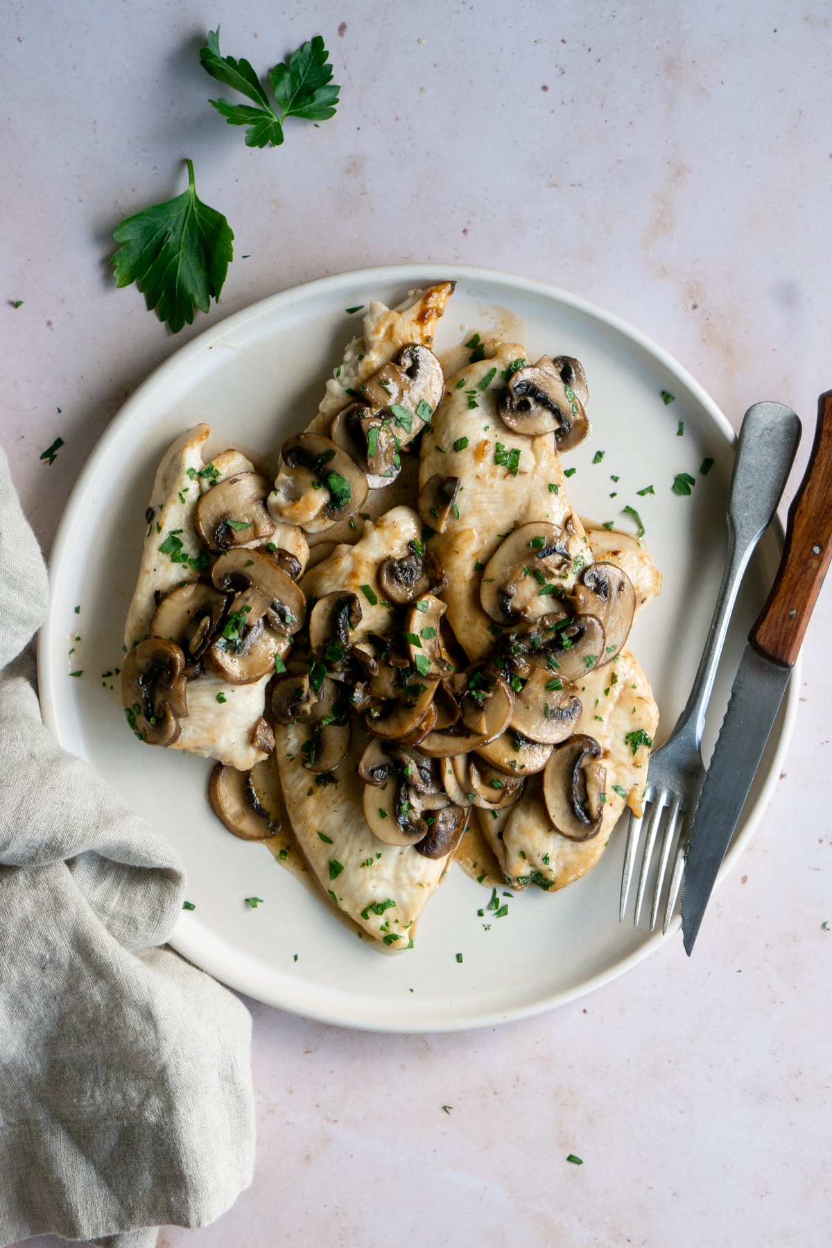 muchroom chicken in a plate with a fork and knife