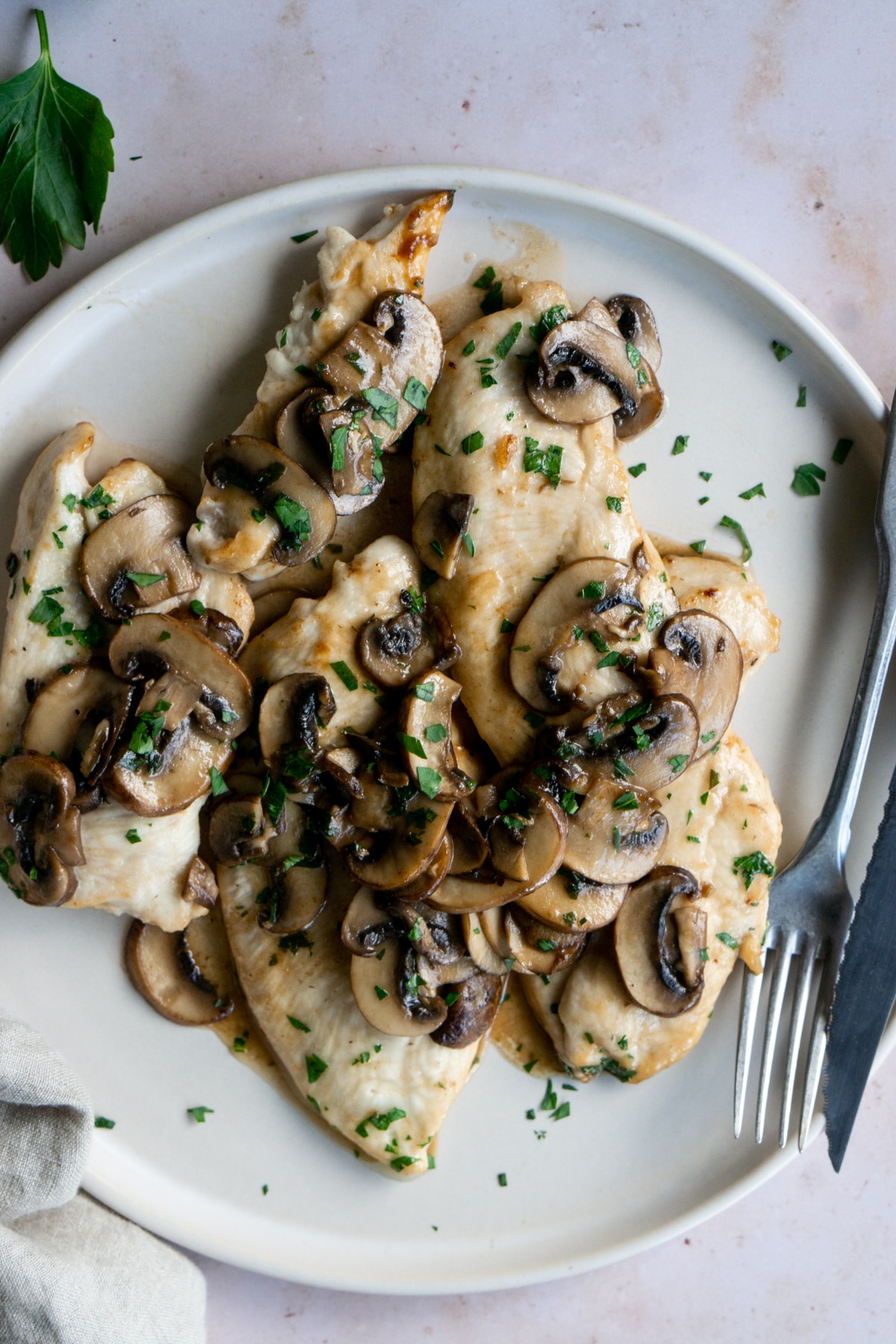Plate of mushroom chicken with a napkin on the side