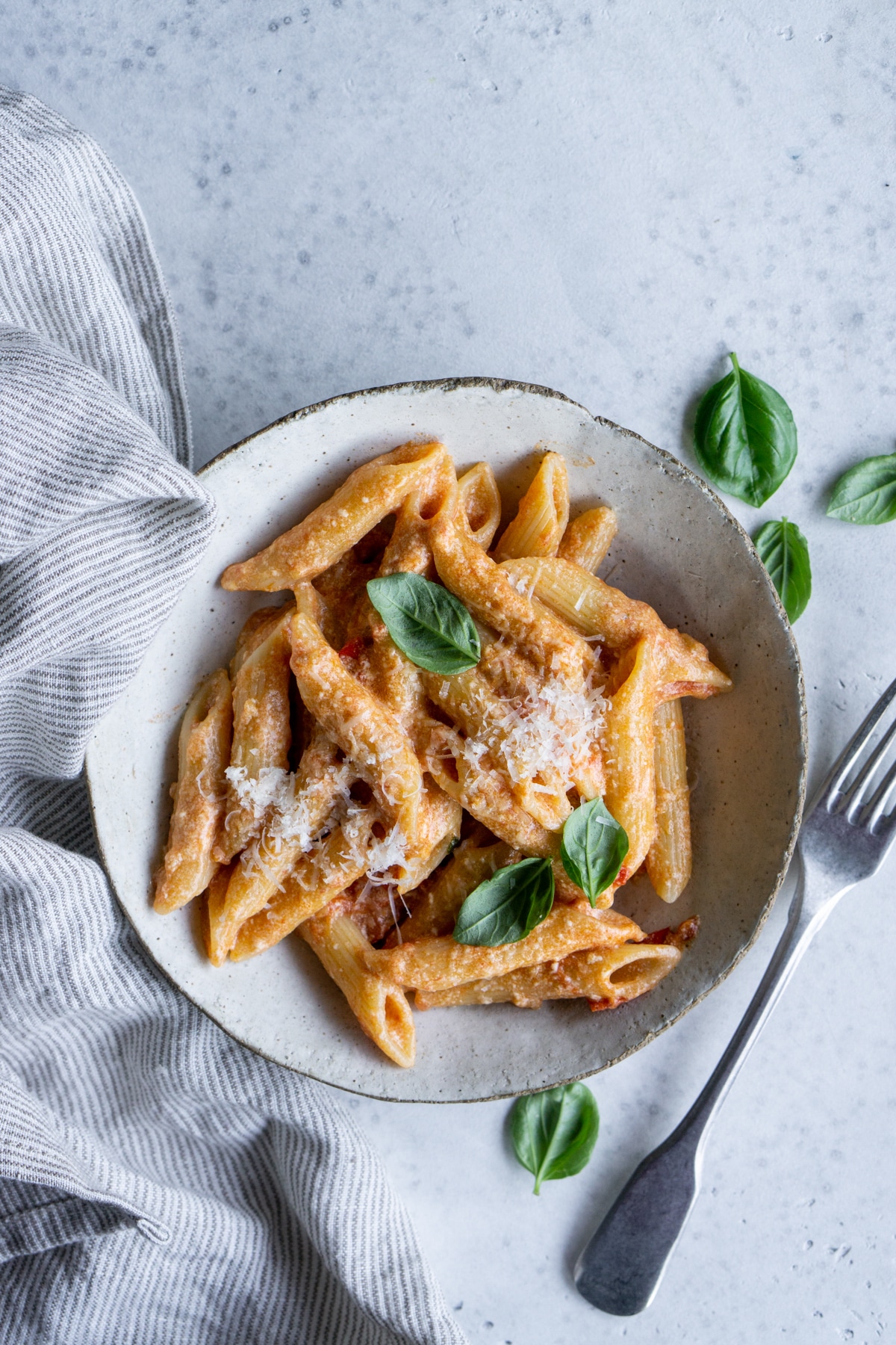 Ricotta pasta with tomato sauce in a bowl with a fork to the side