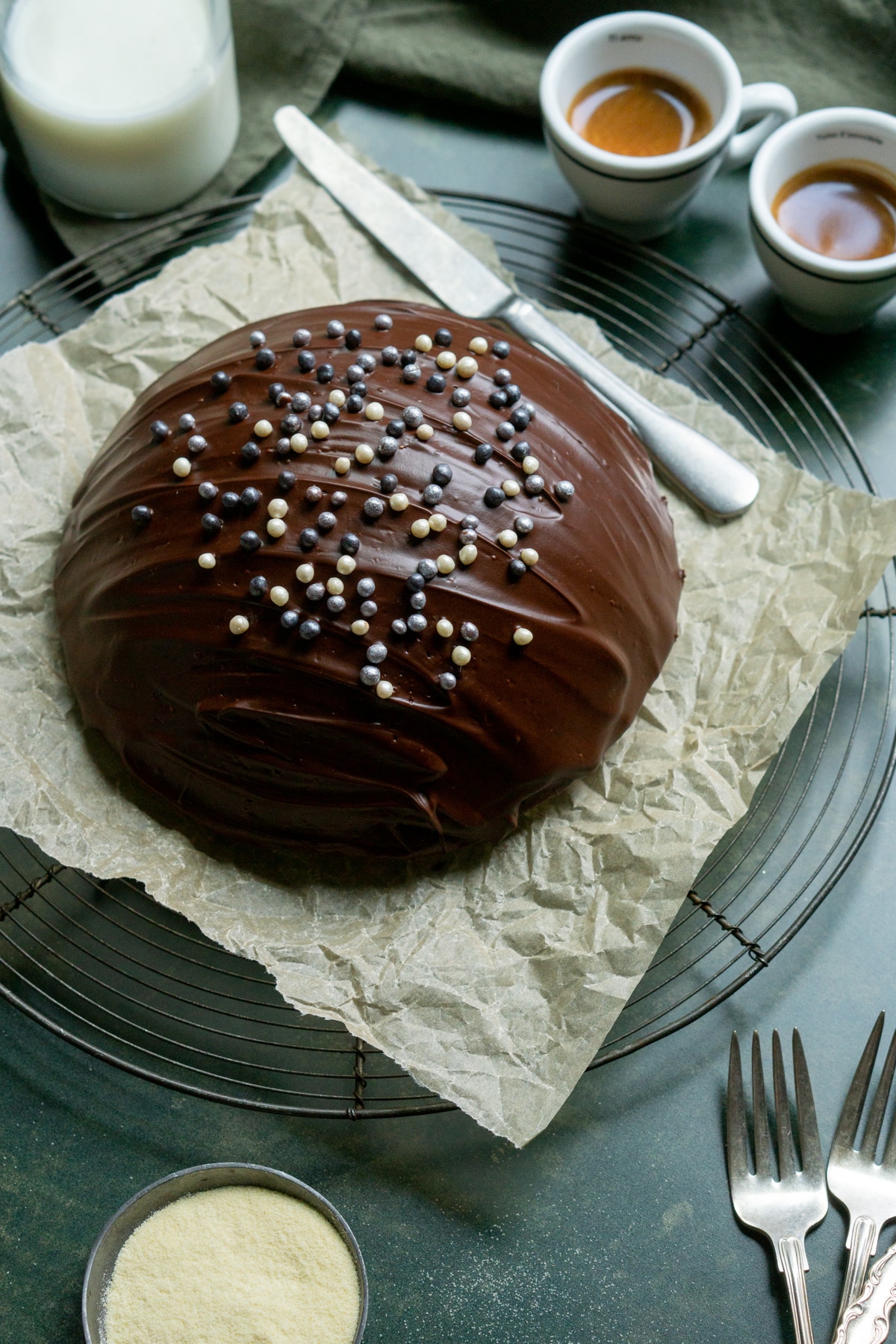 Parrozzo Italian Almond Cake on a drying rack with two espresso iin the background