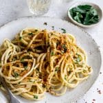 Italian pasta with anchovies in a plate, topped with breadcrumbs