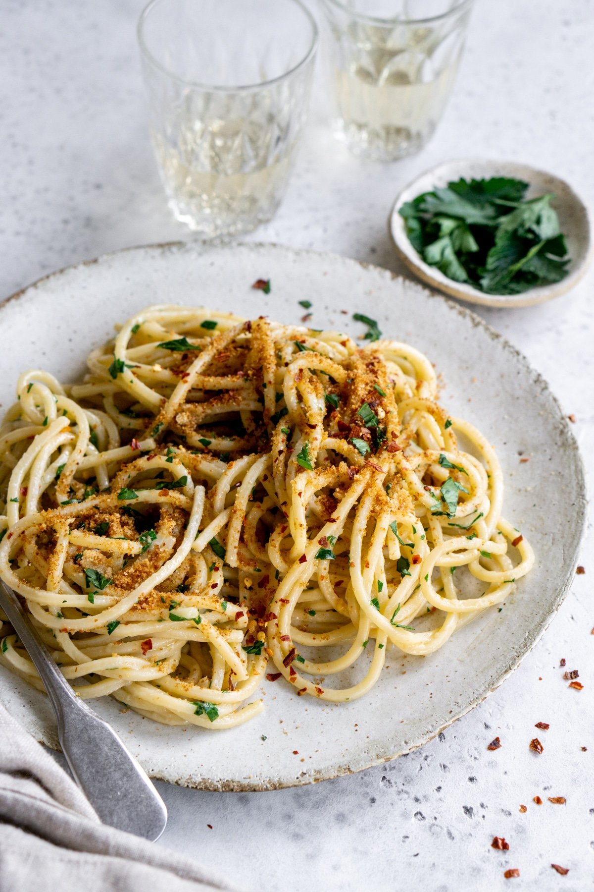 Italian pasta with anchovies in a plate, topped with breadcrumbs