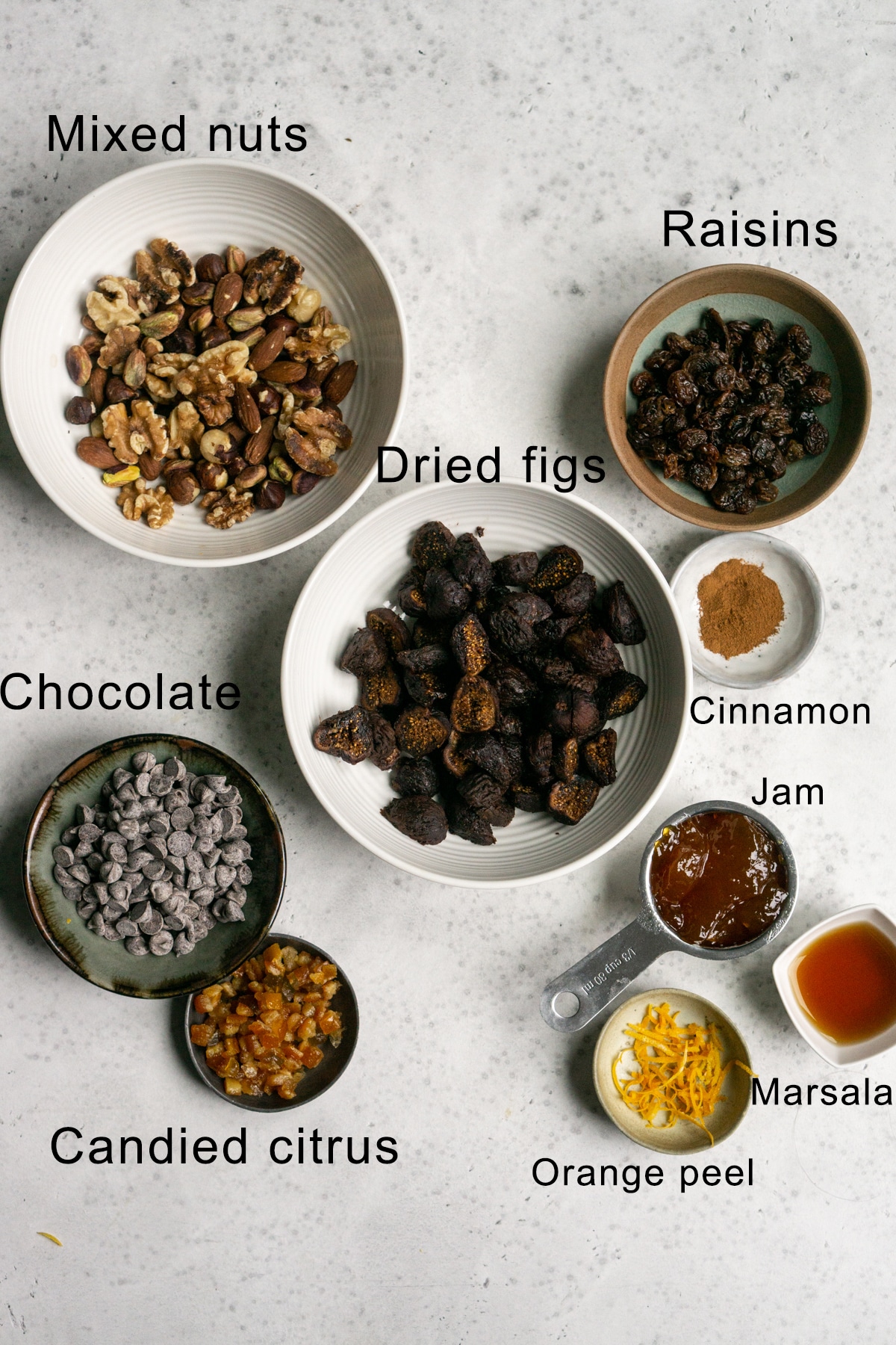 Cuccidati ingredients shot - bowls of nuts, dried figs, chocolate, candied citrus, raisins etc