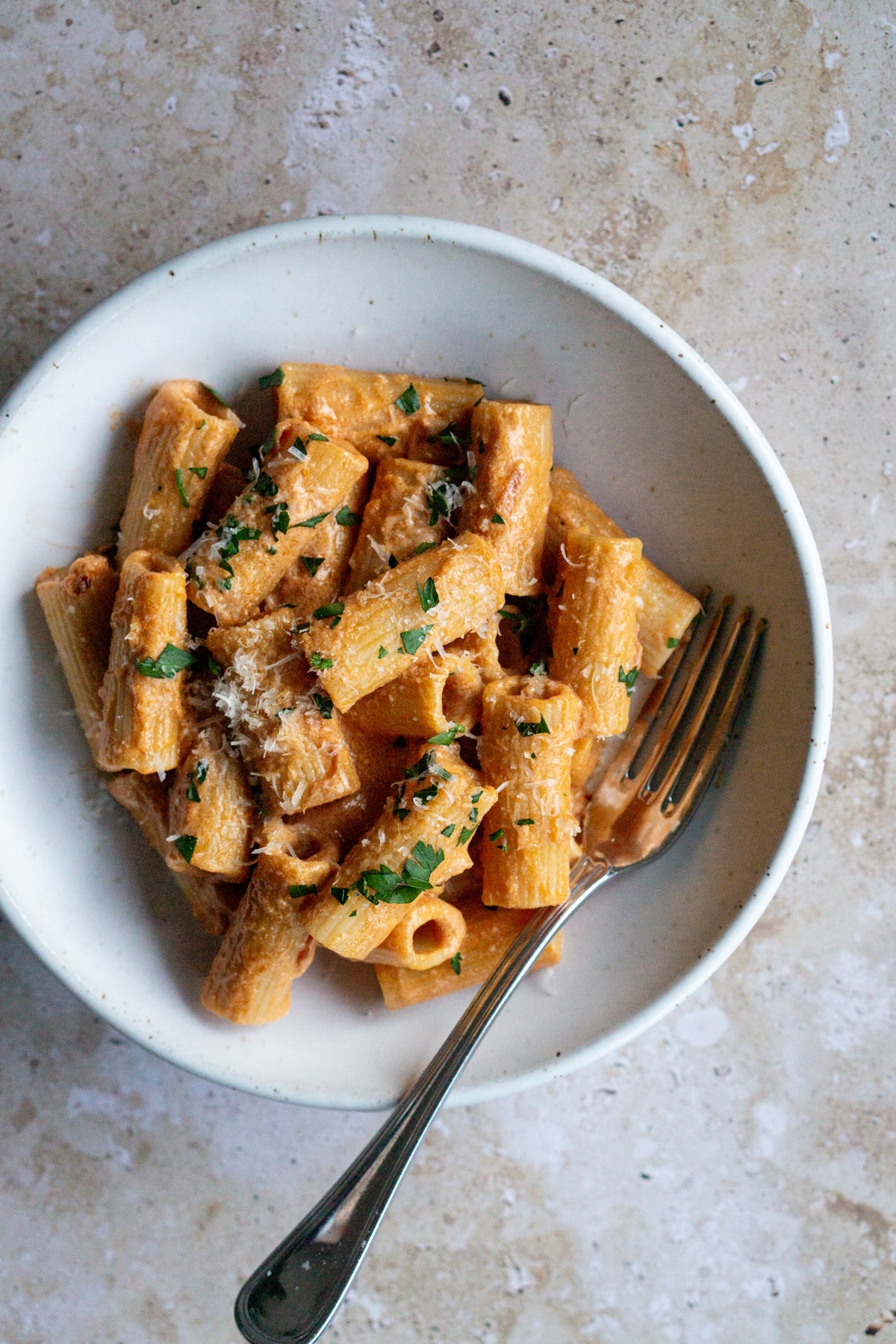 Spicy vodka rigatoni in a plate with a fork