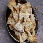 Overhead photo of chicacchiere in a serving tray with crumbs strewn around