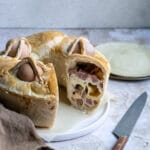 Casatiello - stuffed Italian Easter bread on a plate with a knife to the side