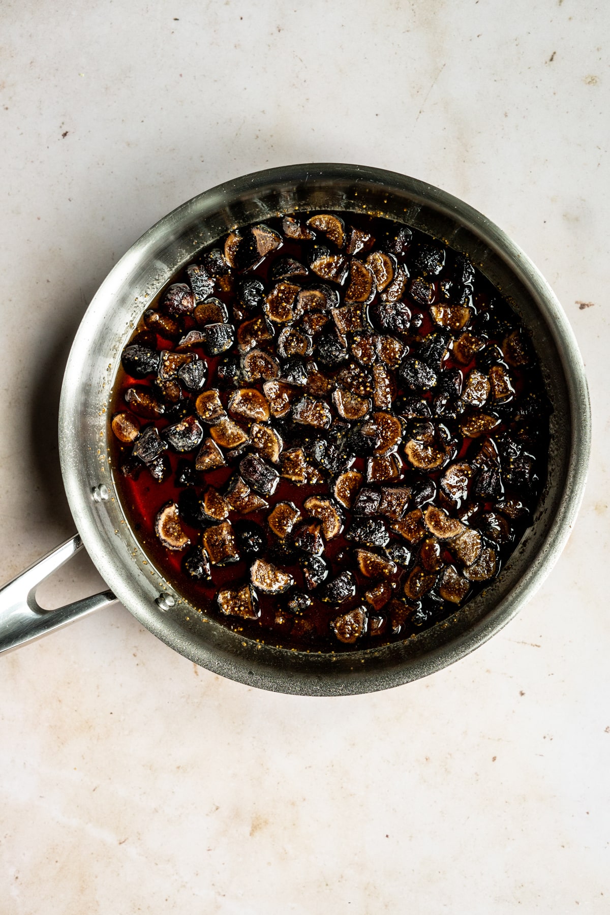Dried figs in a pan with water, sugar, lemon juice and vanilla extract