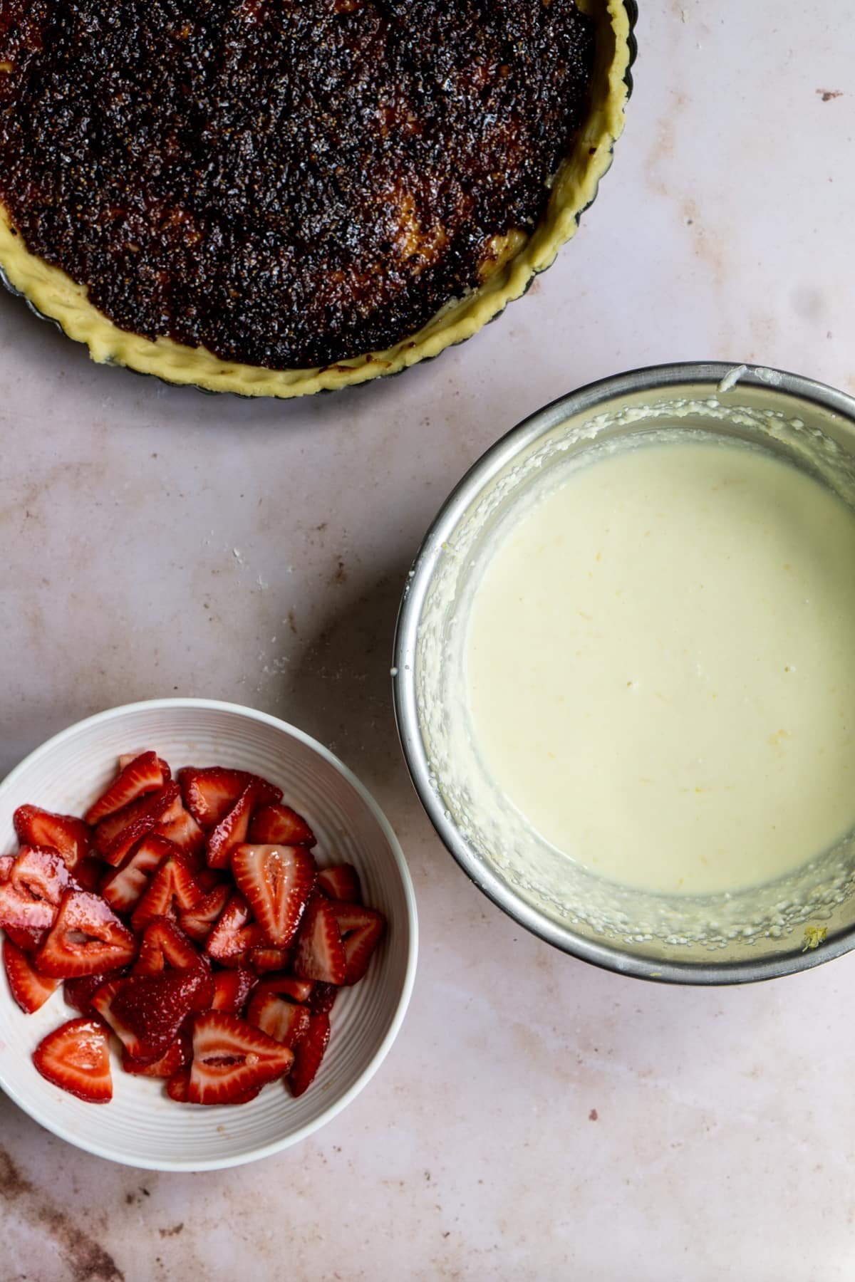 Bowl of ricotta cream and bowl of sliced strawberries