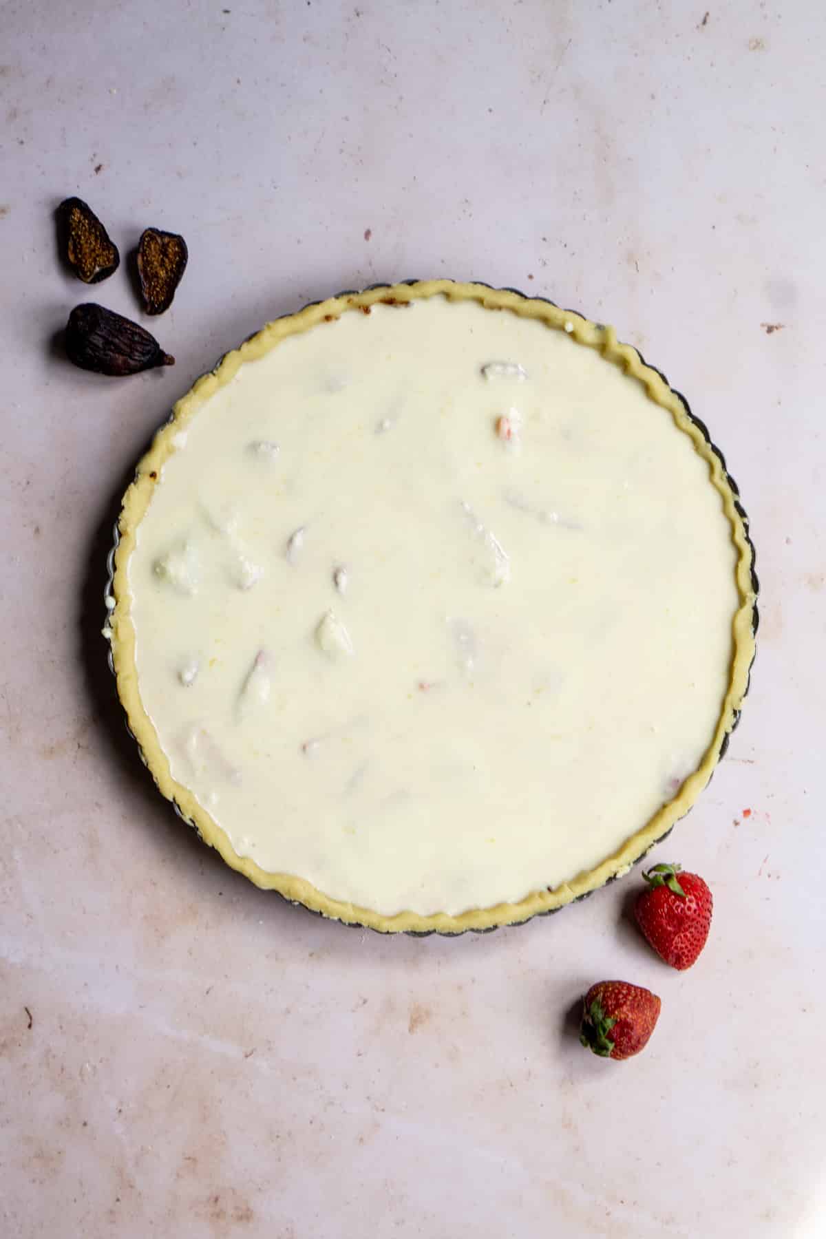 Unbaked strawberry and ricotta crostata in a tart pan