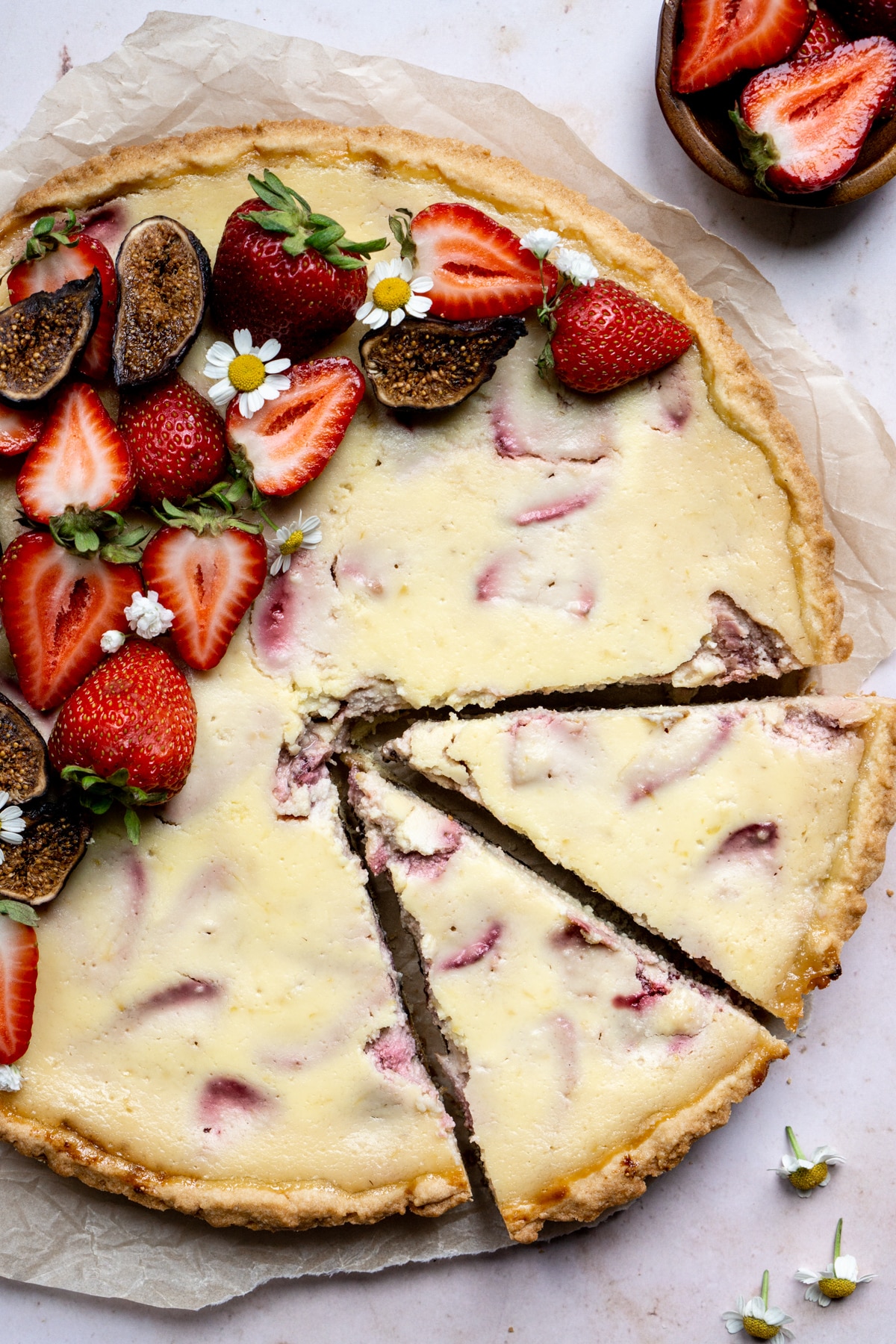 Strawberry and ricotta crostata with two slices cut from it