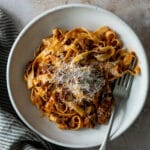 Tagliatelle alla bolognese in a plate with a napkin to the side