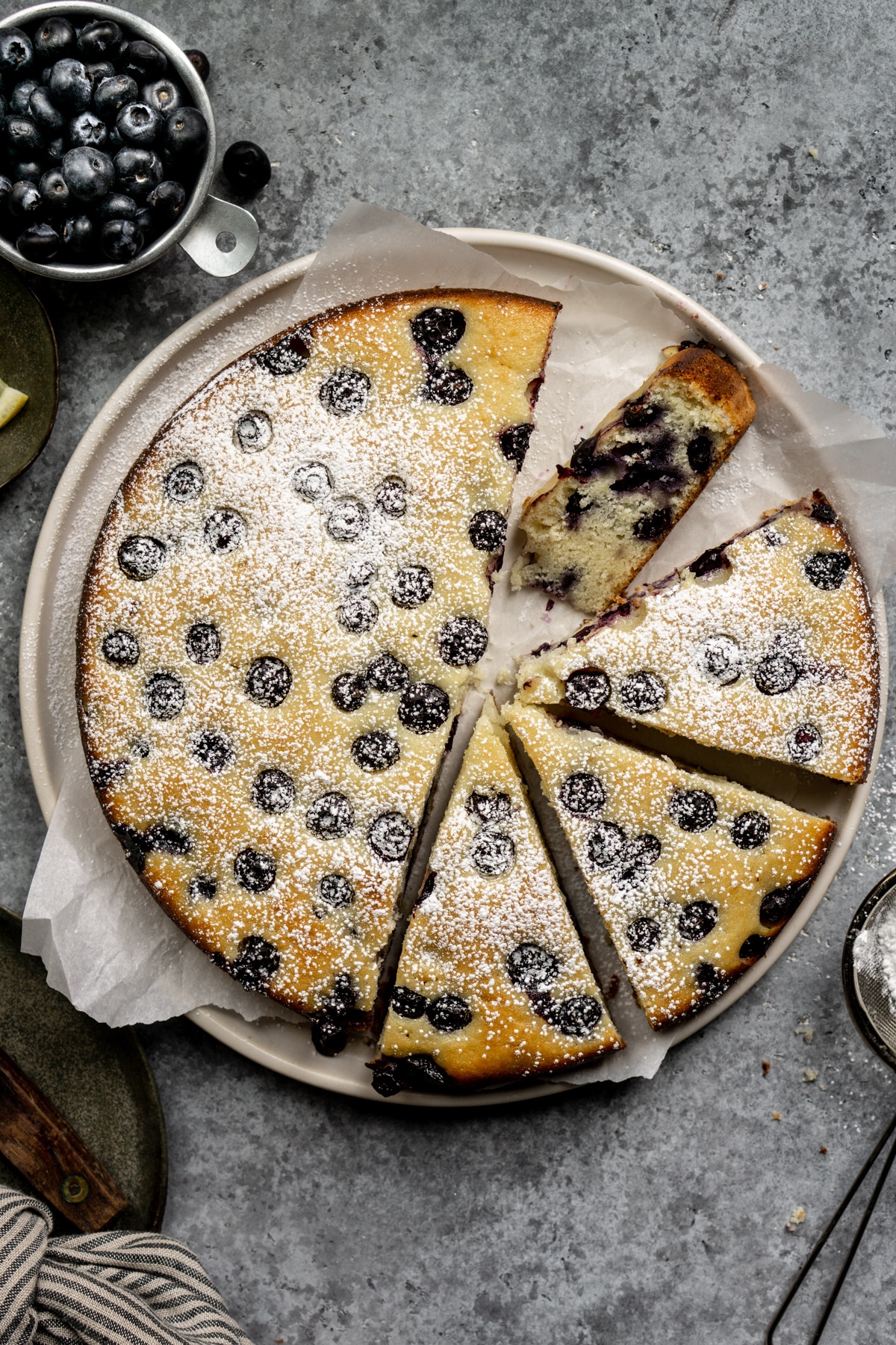 Sliced lemon blueberry ricotta cake in a plate