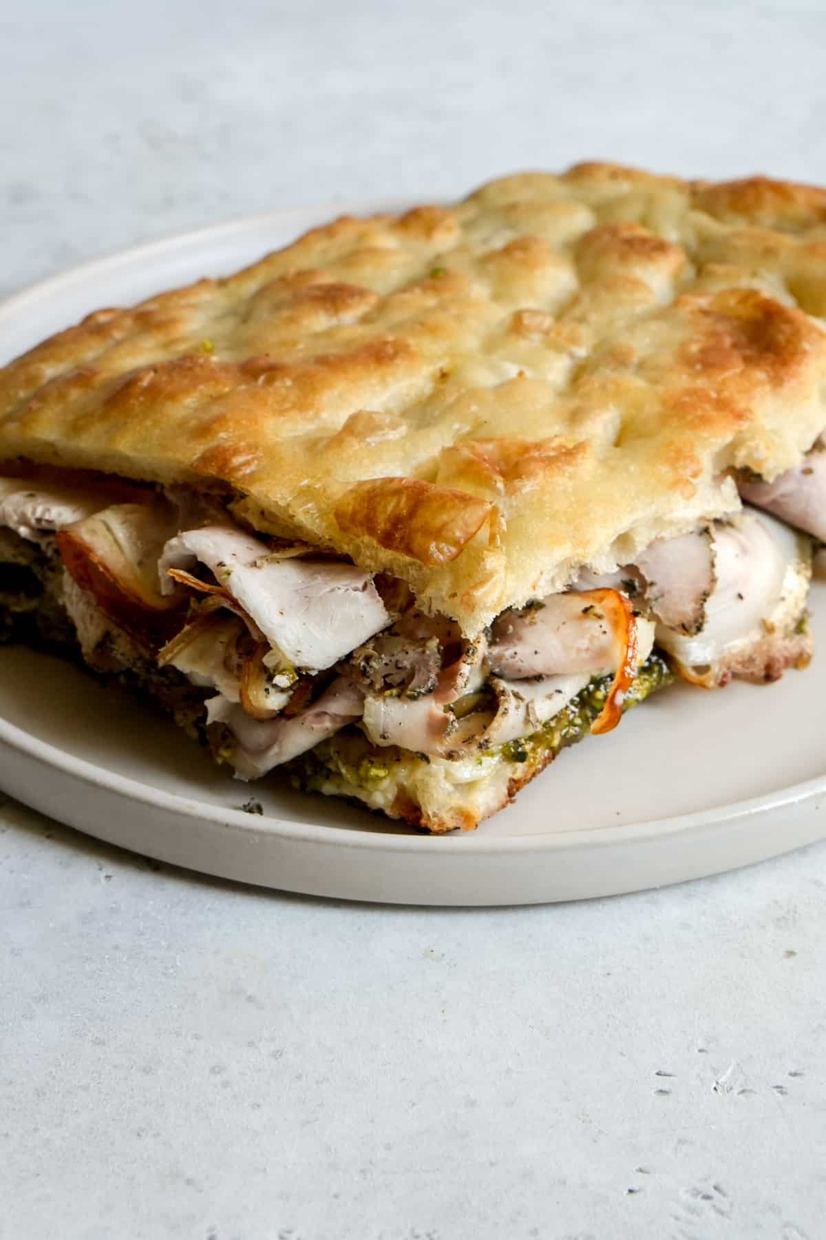 Side view of porchetta panino on a plate