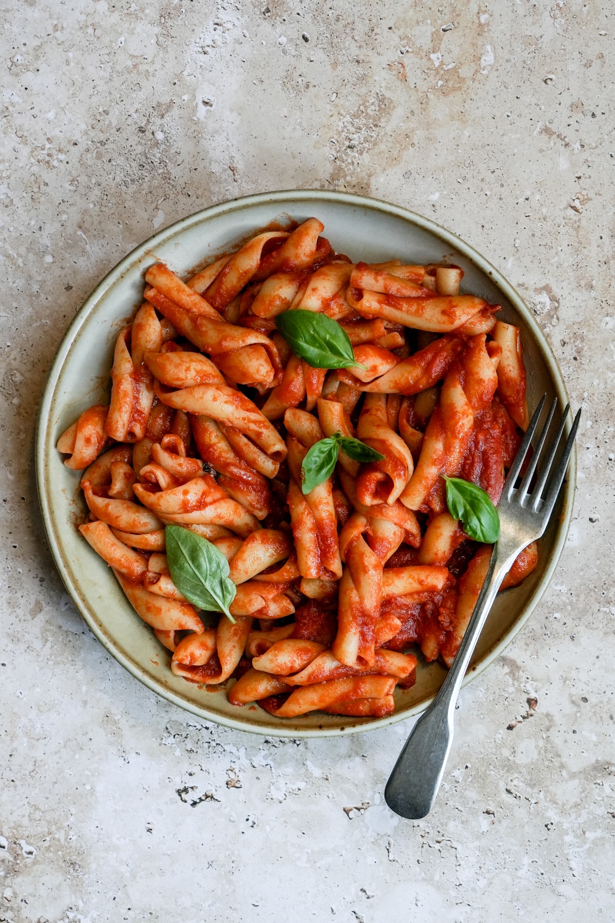 Overhead shot of nduja pasta in a bowl with a fork