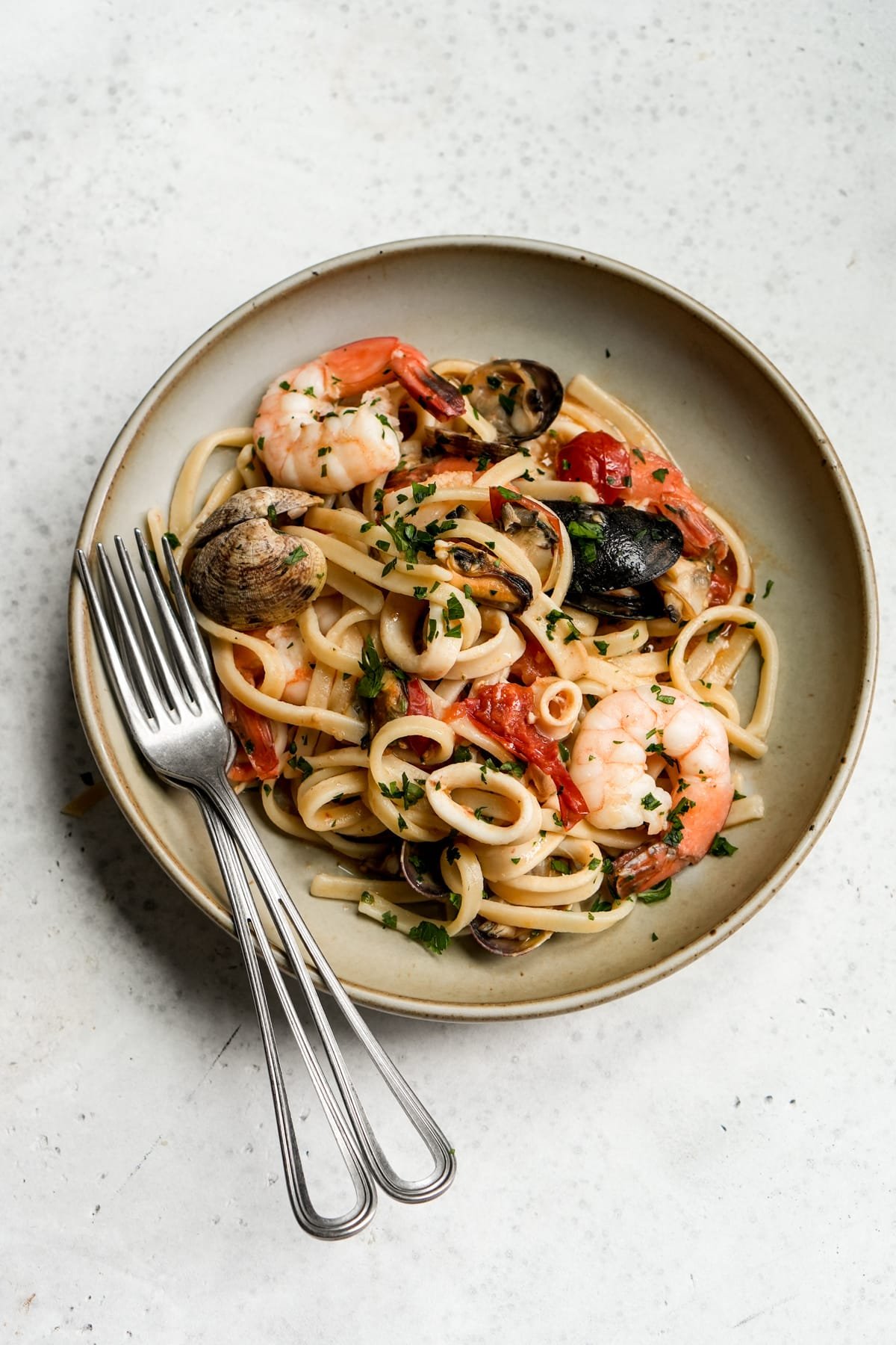 Italian seafood pasta topped with clams, mussels, prawns and calamari in a dish