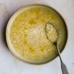 chicken pastina soup in a bowl with a spoon