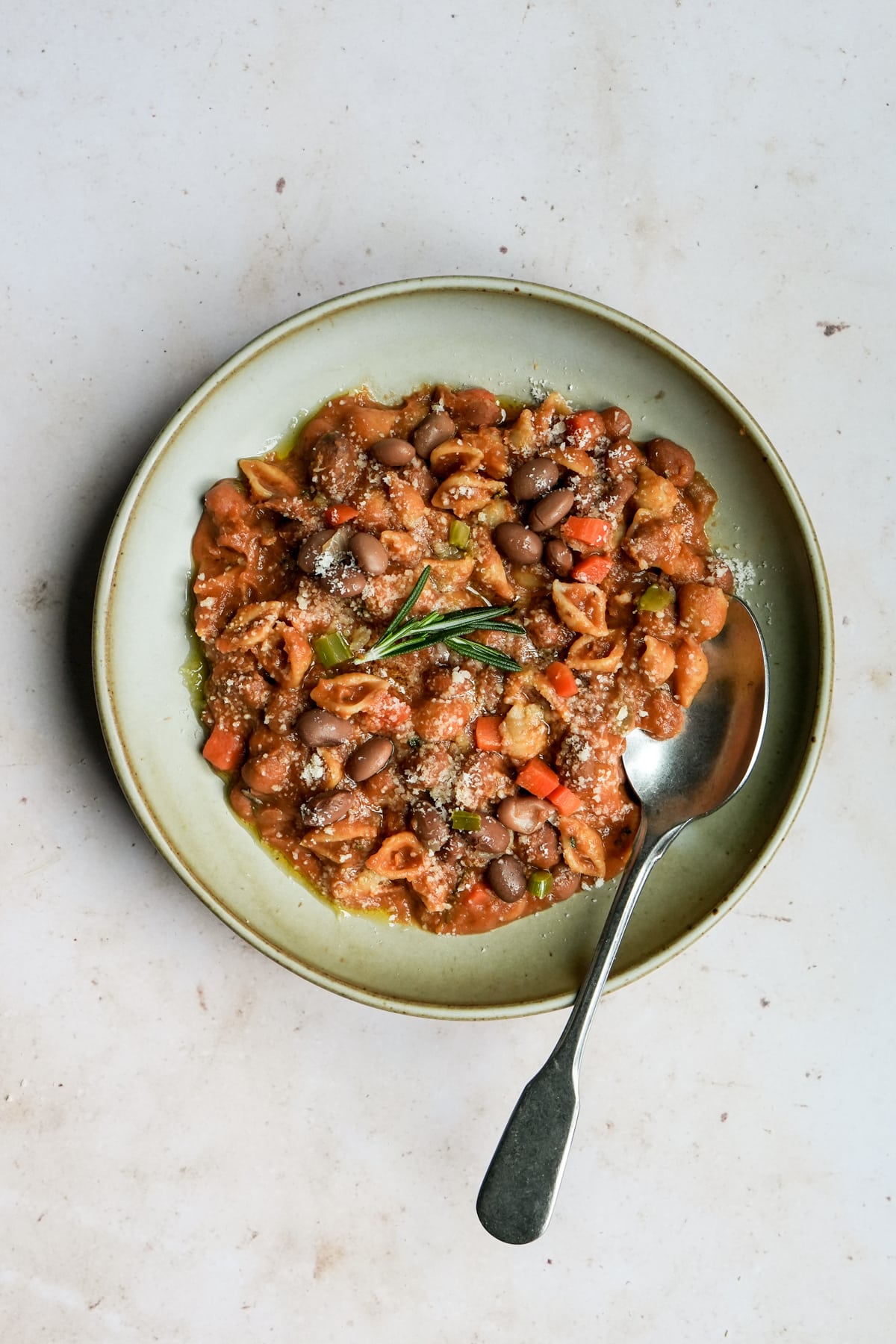 Plate of pasta fagioli topped with parmesan cheese